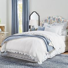 a bed with blue and white comforters in a bedroom