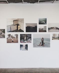 a white wall with many pictures hanging on it