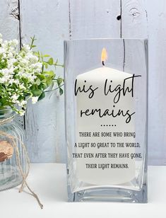 a candle that is sitting next to a vase with flowers in it and the words, this light remains are some who bring a light to the world