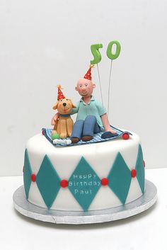 a birthday cake with a man and dog on top