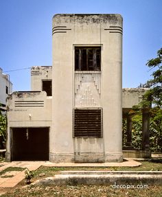 an old building that has been converted into a modern house with windows and shutters