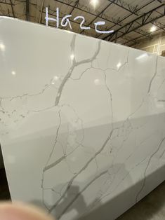 a large white marble counter top in a warehouse with the words hoze written on it