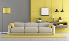 a modern living room with yellow accents and white furniture, including a gray sofa against the wall