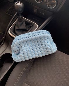 a blue cloth is on the dashboard of a car, next to a steering wheel