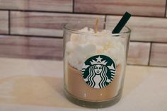 a starbucks drink with marshmallows and a straw sticking out of the top