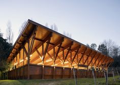 a large wooden structure sitting on top of a lush green field