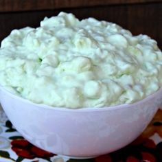 a white bowl filled with food on top of a table