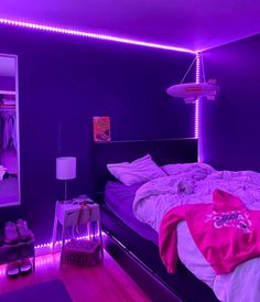 a bedroom with purple lighting and a bed