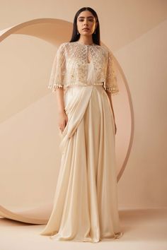 Roqa | Estella Off-White Drape Sari And Cape | INDIASPOPUP.COM Indian Wedding Cocktail Outfits, Cape Top Outfits, Cape Gown Indian, Saree With Cape, Cape Dress Indian, Drape Sari, Indo Western Saree, Cape Dresses, Wedding Guess