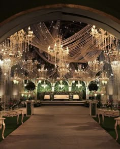 an outdoor wedding venue with chandeliers and tables