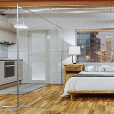 a bedroom with wooden floors and white walls