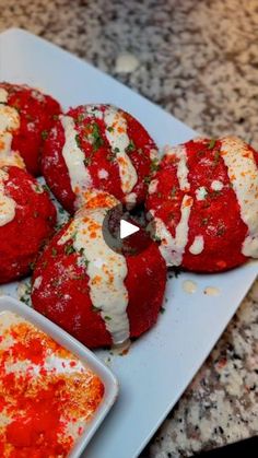 some food is on a white plate with sauce and seasoning next to the bowl