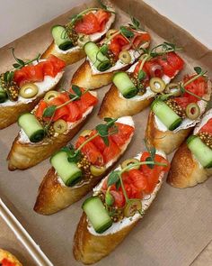 a tray filled with bread topped with lots of different types of food on top of it