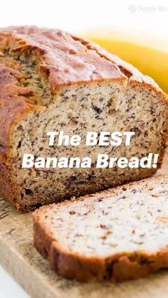 a loaf of banana bread sitting on top of a cutting board next to a ripe banana