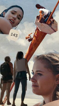 two women and one man are standing on the beach with an upside down boat in front of them