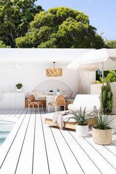 an outdoor living area next to a swimming pool