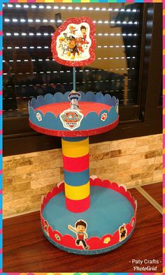 there is a cake stand with toy story on it in the shape of a circus tent