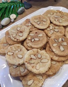 there is a platter full of cookies with almonds on it