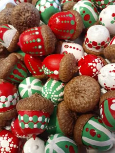 a bowl filled with lots of different types of decorated eggs on top of each other