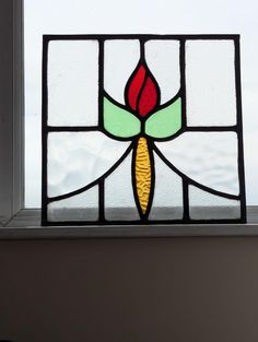 Superb compact 1930's stained glass panel.  Lovely flowing design with pretty yellow/red flower form with green foliage. the panel has a nice square aspect.  Glass and lead work cleaned and polished to arrive looking its best.  There are some unevenness to lead work  but this does not detract from the panels appearance or stability. Looks amazing placed informally in front of a window or a light source to enjoy this particularly lovely panel. Size Width 36 cm Height 36  cm Antique Stained Glass Windows, Antique Stain, Stained Glass Window Panel, Pretty Yellow, Panels Wall, Stained Glass Panel, Architectural Antiques, Glass Panel, Stained Glass Window