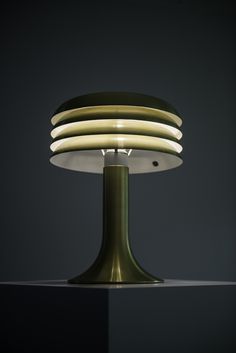 a table lamp sitting on top of a black surface