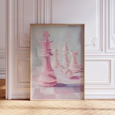 a painting of pink chess pieces in front of a white wall and wooden flooring