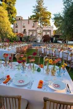 a table set up with plates and flowers