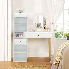 a white desk with a mirror and shelf on top of it next to a bed