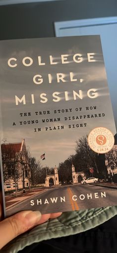 the book college girl missing is held up in front of a person's hand