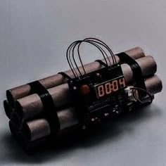 an electronic device with four tubes attached to it's back and two wires running through the middle