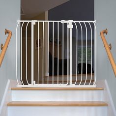 a stair gate is open to allow people to walk up and down the stairs in their home