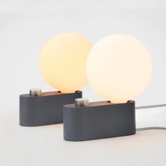 two lamps sitting next to each other on a table