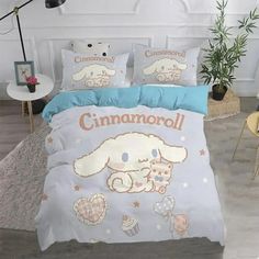 a bed room with a neatly made comforter and pillows on top of the bed