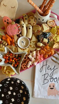 a table topped with lots of different types of cookies and candies on top of a plate