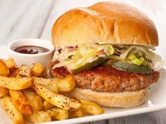 a sandwich and french fries on a white plate