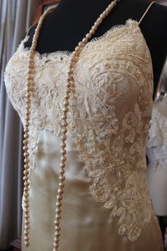 a mannequin with pearls and lace on it