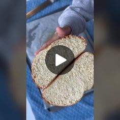 a person holding two slices of bread in their hands, with the video showing them