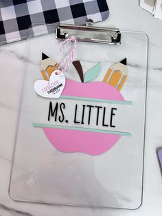 a clipboard with an apple on it and the words ms little attached to it