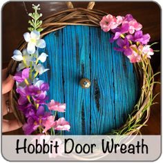 a hobbit door wreath with purple and white flowers