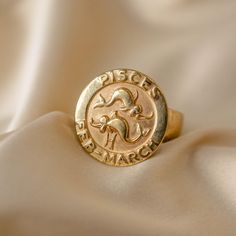 We love a vintage zodiac piece, especially one as wearable as this ring. Crafted from 9k yellow gold, it features two fish in relief at the center, representing the classic Pisces yin-yang. The word "Pisces" completes the design, making it detailed and chic--perfect for the twelfth sign. With its smooth, classic shape, it's comfortable and ideal for everyday wear, whether worn alone or stacked. Zodiac rings are rare, so if you're a Pisces, this is your chance!  Details: Size: 5 1/2  Hallmarked: London 1966 Vintage Zodiac, Zodiac Rings, March Birthday, Two Fish, Boulder Co, Pisces Zodiac, Signet Ring, Yin Yang, Provence