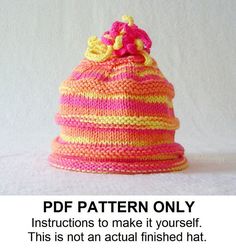 a pink and yellow knitted hat with flowers on the top that says, pattern only instructions to make it yourself this is not an actual finished hat