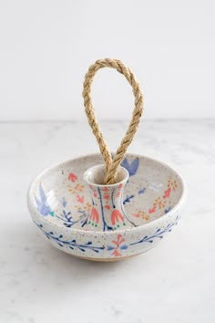 a bowl with rope in it on a table