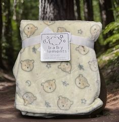 a baby blanket with bears on it in the woods