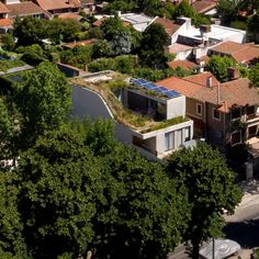 an aerial view of houses with rooftops and trees