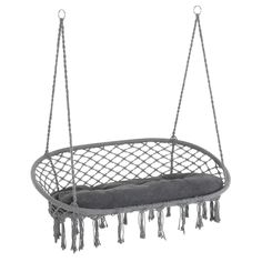 a gray hanging chair with tassels on it