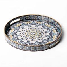 a blue and white tray with an ornate design