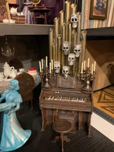 a skeleton figurine sitting next to an old fashioned organ with skulls on it