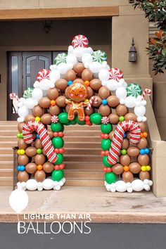 an inflatable gingerbread house is on display at the entrance to a home