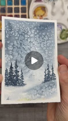 someone is holding up a card with snow on it