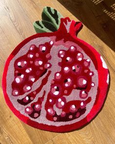 a red pomegranate rug on the floor